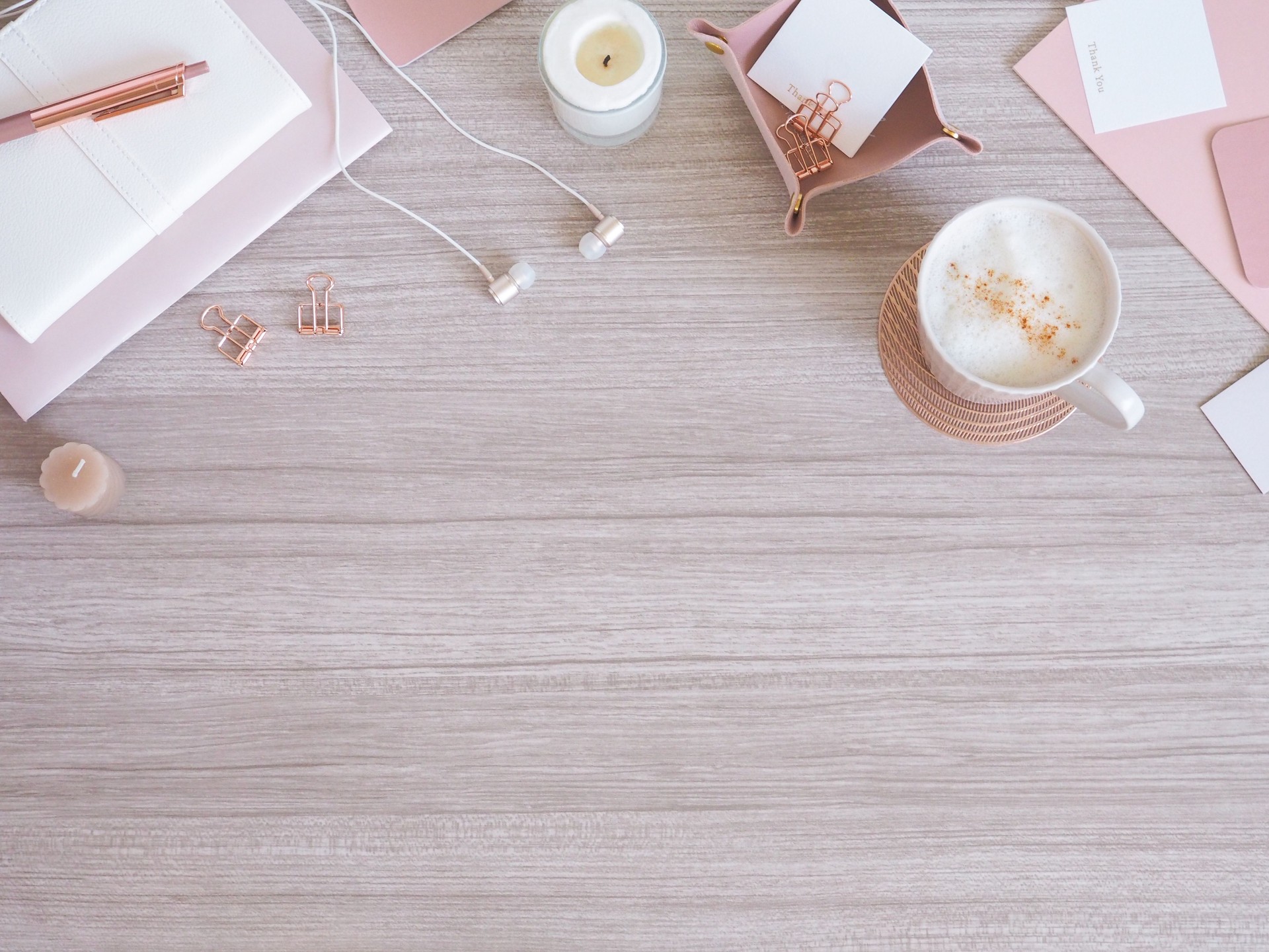 Top view image of a relaxing desk based on light wood grain and pink beige, desk with a feminine and soft atmosphere